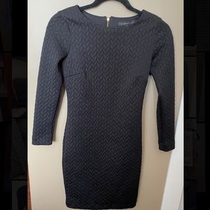 Knee length black dress with gold accents